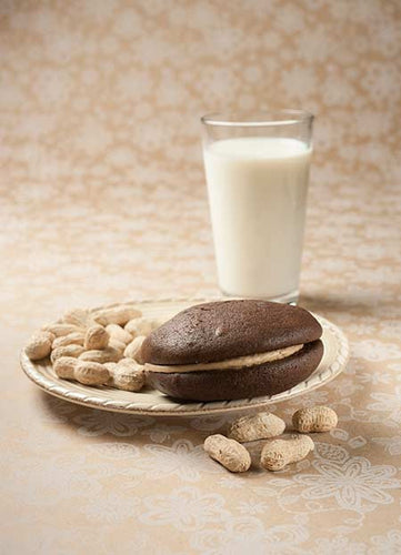 peanut butter whoopie pie with peanuts and milk