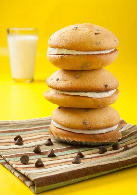 3 pumpkin chocolate chip whoopie pies stacked on top of each other
