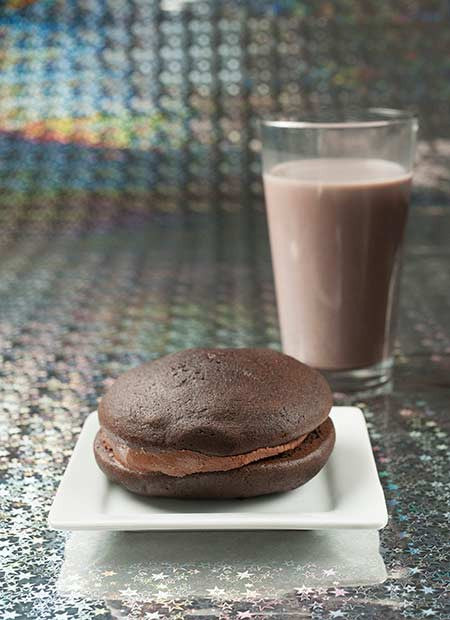 double chocolate chip whoopie pie with chocolate milk in the background