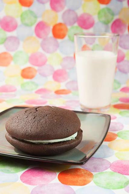 Mint whoopie pie with a glass of milk